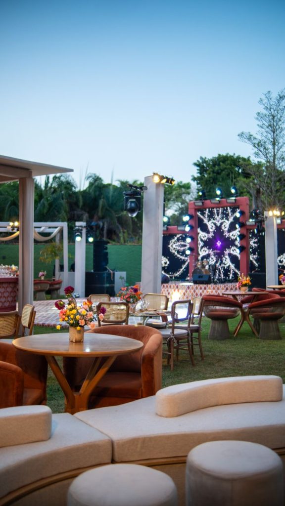 Luxurious outdoor event setup featuring elegant decor and a vibrant stage, perfect for celebrations.